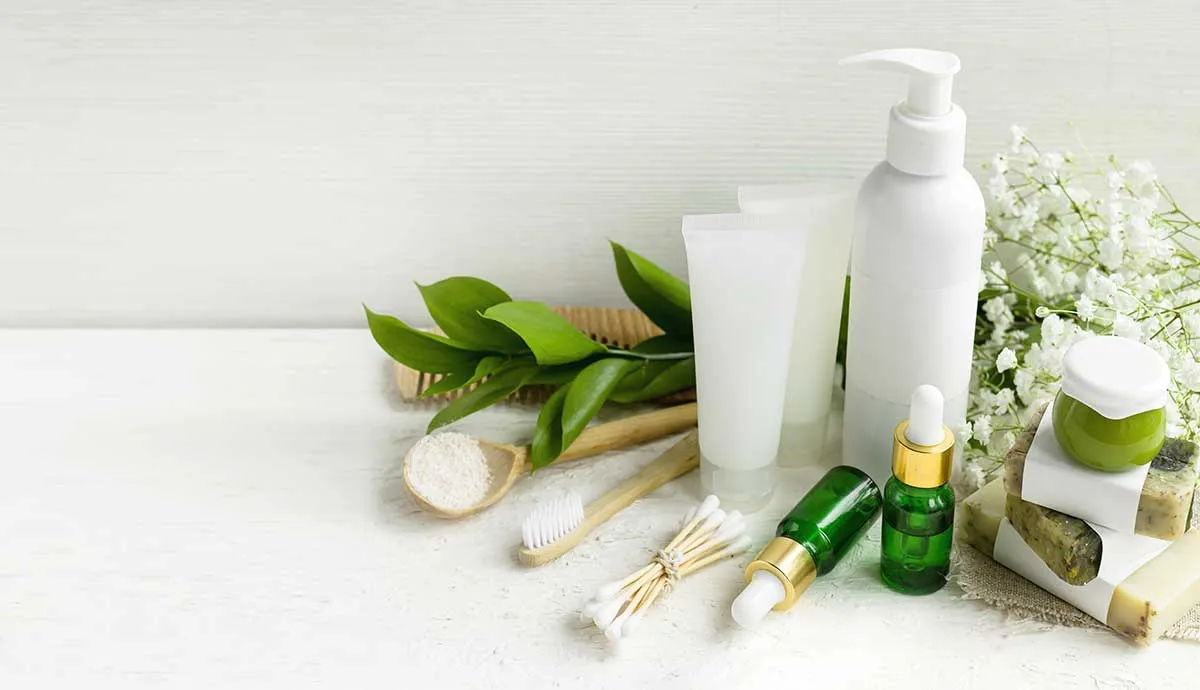 white cosmetic packaging on counter surrounded by floral