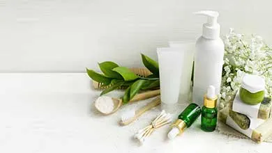 white cosmetic packaging on counter surrounded by floral