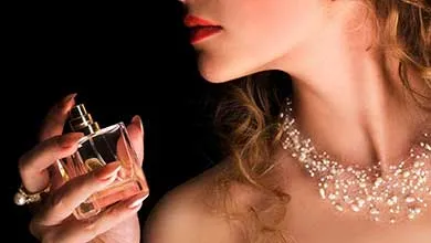 female holding perfume bottle