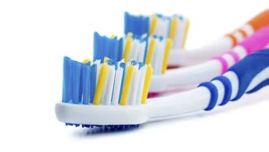 Row of three tooth brushes
